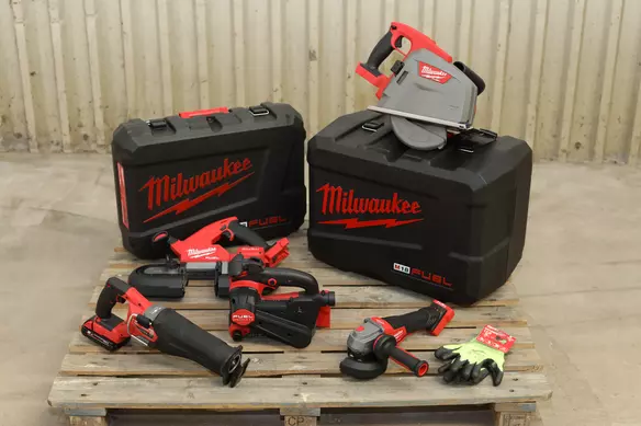  a set of power tools from Milwaukee placed on a table next to protective cases