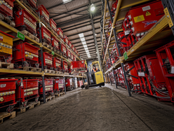 a photo showing inside a warehouse between 2 rows of equipment