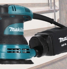 a sander with a staircase background