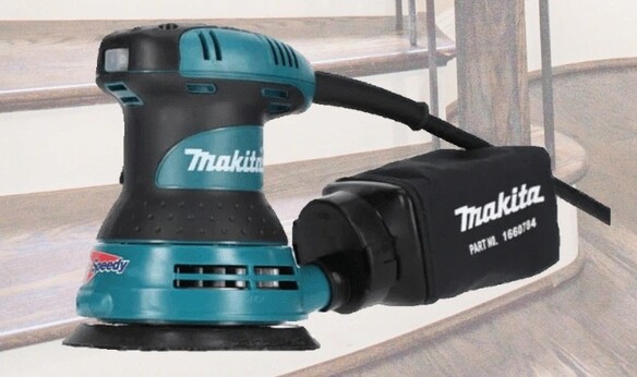 a sander with a staircase background