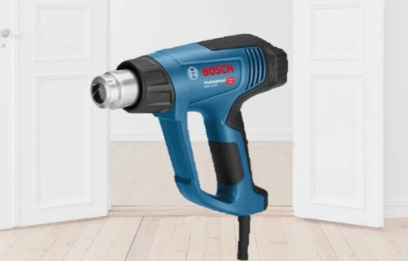 Bosch heat gun to remove paint with a modern house background