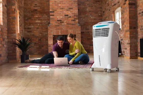 a white air conditioner is used to cool down a room