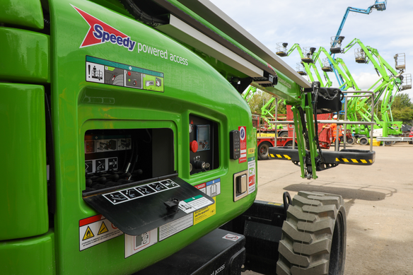 Close-up of a green Speedy powered access boom lift with its control panel open