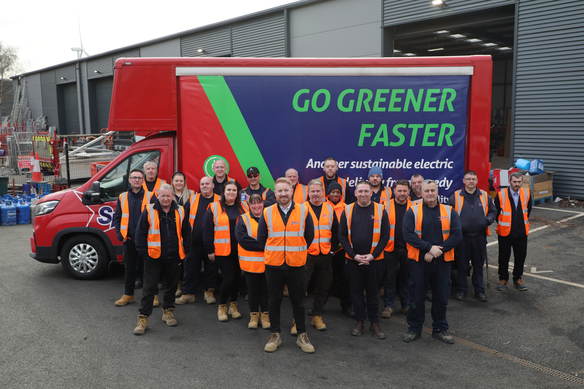 Speedy staff standing in front of a truck saying Go Green Faster