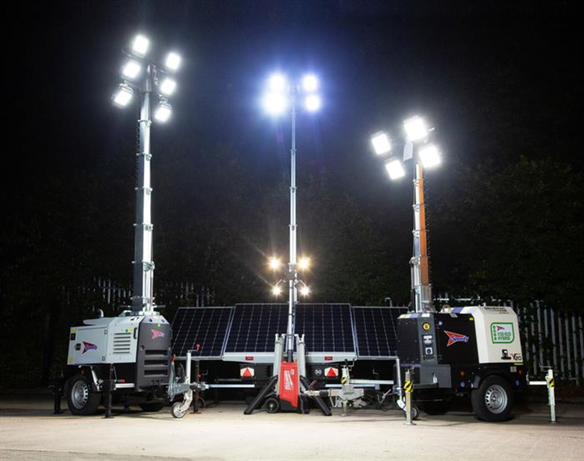 3 hybrid lighting towers in use on a construction site during night