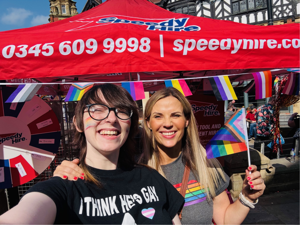 2 Speedy staff at Wigan Pride holding a pride flag