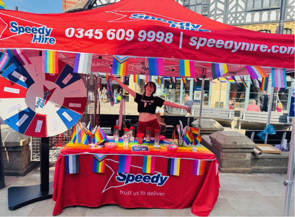a Speedy professional at Wigan Pride standing inside a booth