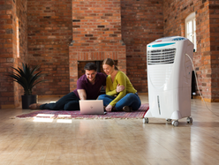 a couple using an air conditioner in their house