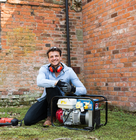 a man using a generator in his garden