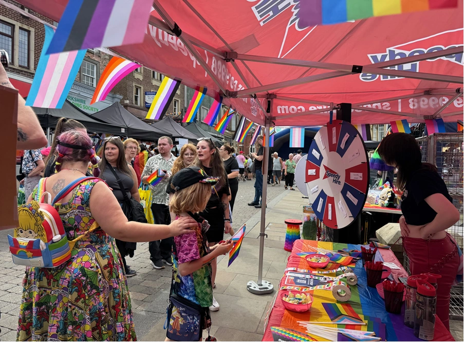 children and adults supporting Speedy booth at Wigan Pride